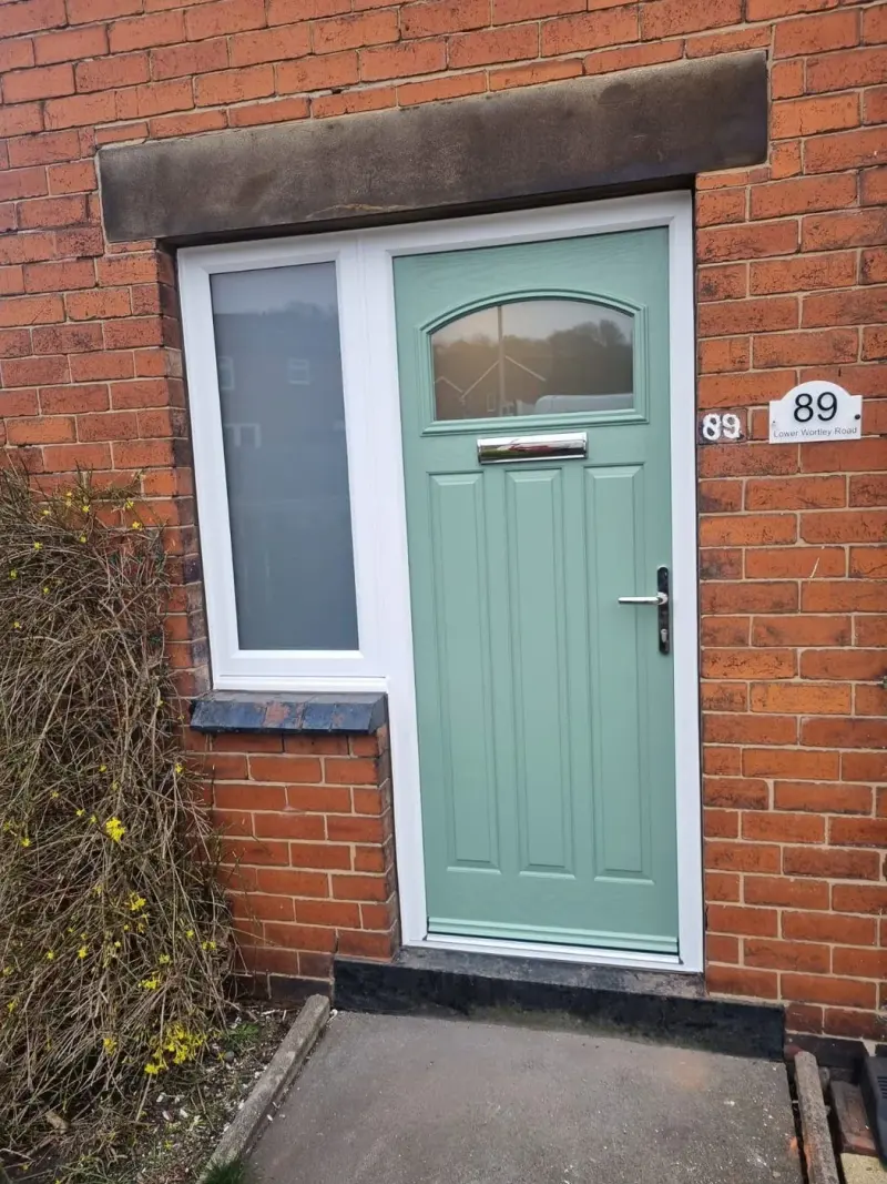 Chartwell-green composite door with a white frame and sidelight on a 1930s house, house number 89 on the door plate.